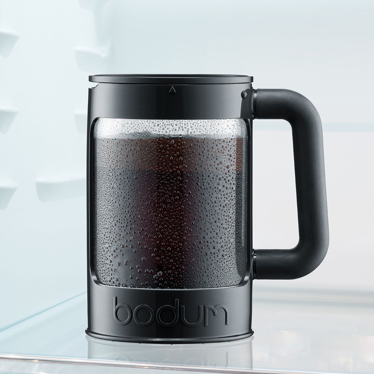 Black Bodum coffee maker with coffee inside on a light background