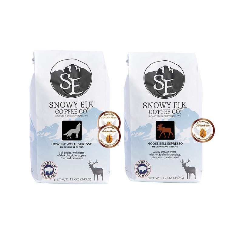 Two bags of Snowy Elk Coffee Co. espresso, one labeled 'Dark Moose Espresso Blend' and the other 'Howlin' Wolf Espresso Blend'. Two bags of Snowy Elk Coffee Co. espresso, one labeled 'Dark Moose Espresso Blend' and the other 'Howlin' Wolf Espresso Blend'.