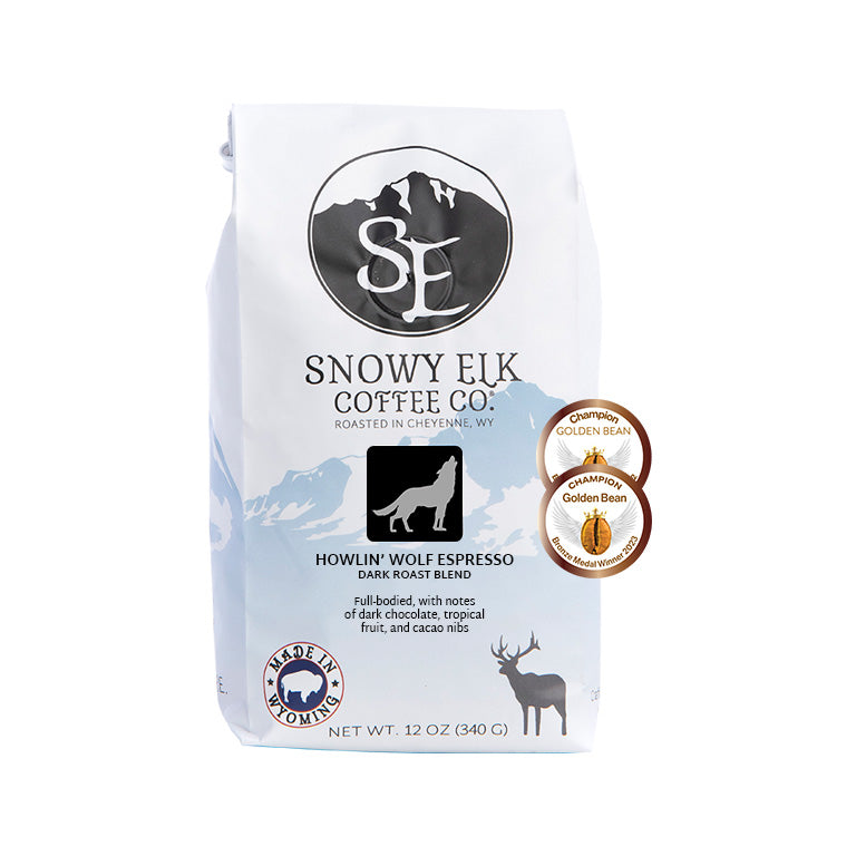 A bag of Snowy Elk Coffee Co. Howlin' Wolf Espresso with a label showing a silhouette of a wolf and mountains. A bag of Snowy Elk Coffee Co. Howlin' Wolf Espresso with a label showing a silhouette of a wolf and mountains.
