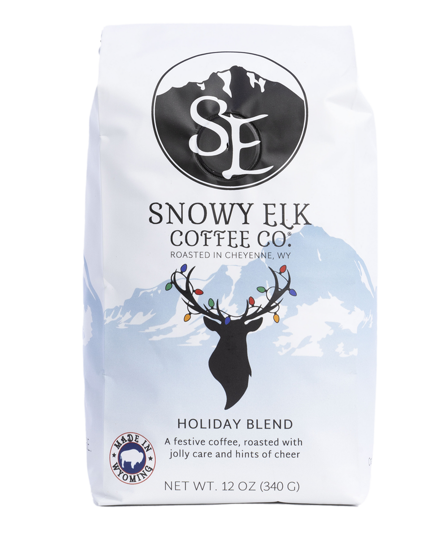 A white and blue bag of medium roast coffee with a picture of a deer with Christmas lights on the antlers. A white and blue bag of medium roast coffee with a picture of a deer with Christmas lights on the antlers.
