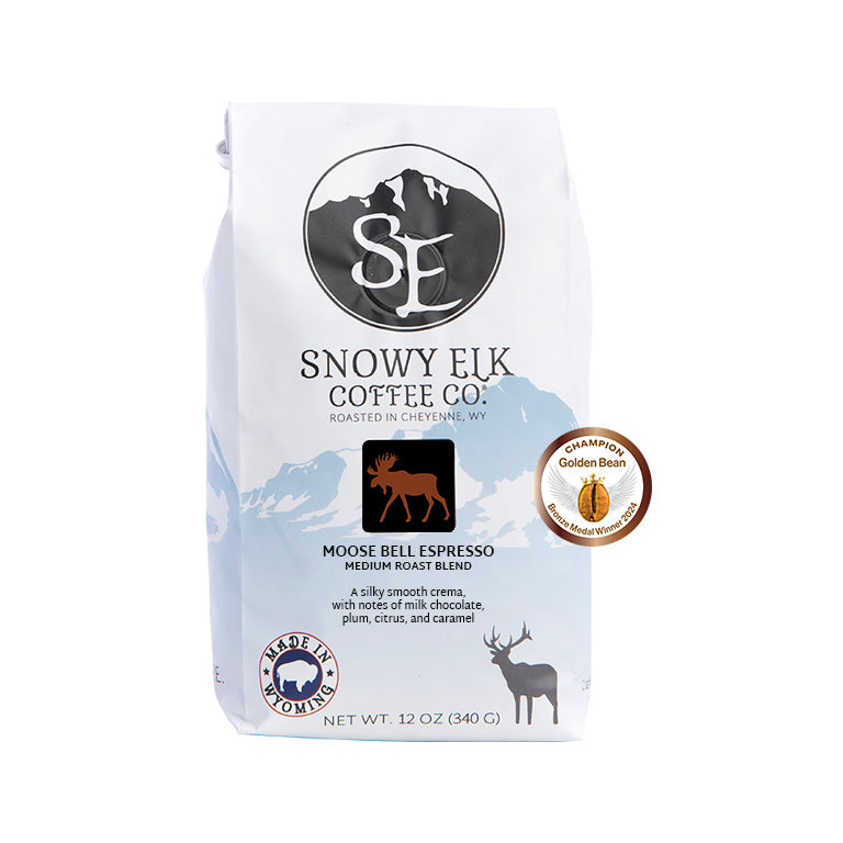 A bag of Snowy Elk Coffee Co. Moose Bell Espresso, showing the packaging which includes the brand logo, a moose illustration, and a seal indicating medium roast.