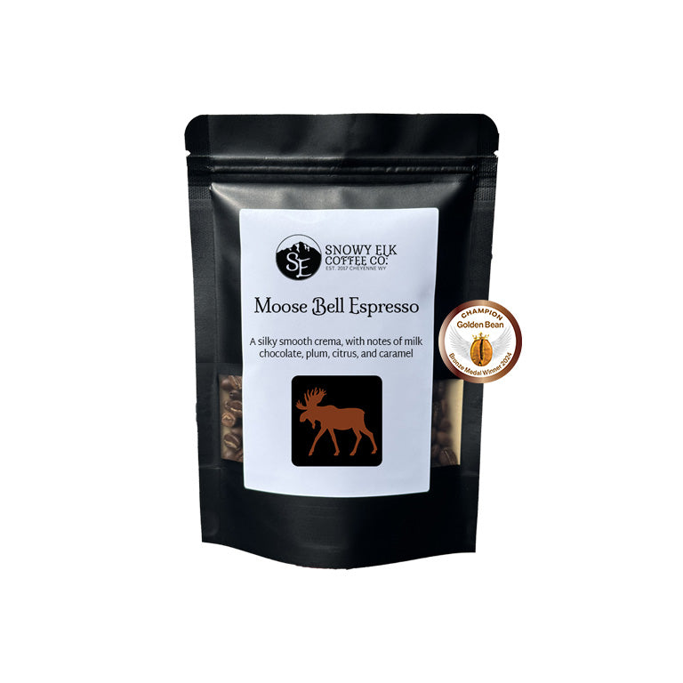 Black coffee bag with 'Snowy Elk Coffee Co.' branding and 'Moose Bell Espresso' label on a white background. Black coffee bag with 'Snowy Elk Coffee Co.' branding and 'Moose Bell Espresso' label on a white background.