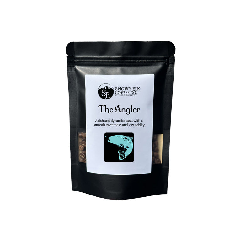 Black coffee bag labeled 'The Angler' from Snowy Elk Coffee Co. on a white background Black coffee bag labeled 'The Angler' from Snowy Elk Coffee Co. on a white background