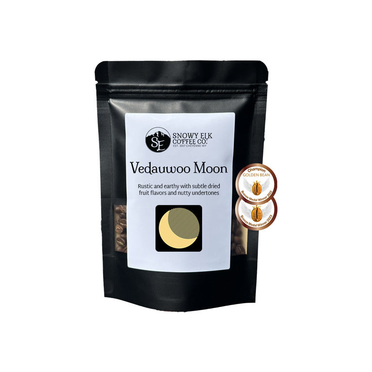 Black coffee packaging with 'Snowy Elk Coffee Co' branding and product name 'Vedauwoo Moon'. Black coffee packaging with 'Snowy Elk Coffee Co' branding and product name 'Vedauwoo Moon'.