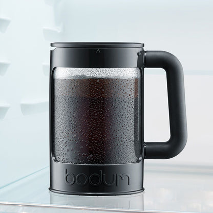 Black Bodum coffee maker with coffee inside on a light background