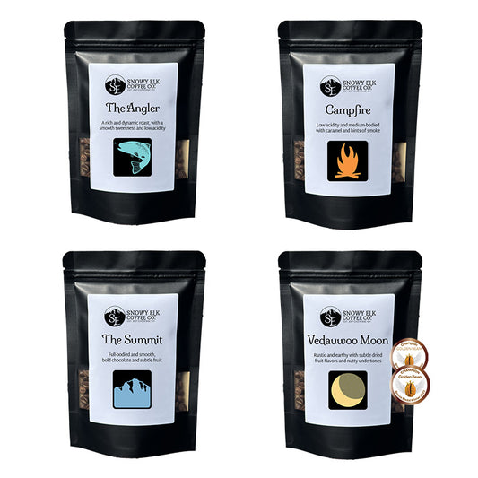 Four black coffee bags with labels on a white background Four black coffee bags with labels on a white background