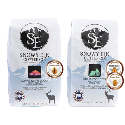 Two bags of Snowy Elk Coffee Co. decaf coffee.