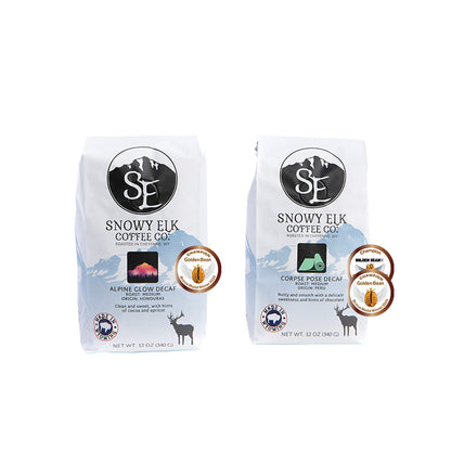 Two bags of Snowy Elk Coffee Co. decaffeinated coffee.