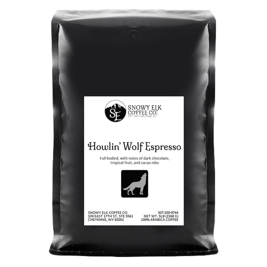 A bag of Snowy Elk Coffee Co. Howlin' Wolf Espresso with a label showing a silhouette of a wolf and mountains.