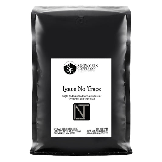 A bag of Snowy Elk Coffee Co. coffee with a label that includes a deer and the text 'Leave No Trace', indicating a medium roast level.