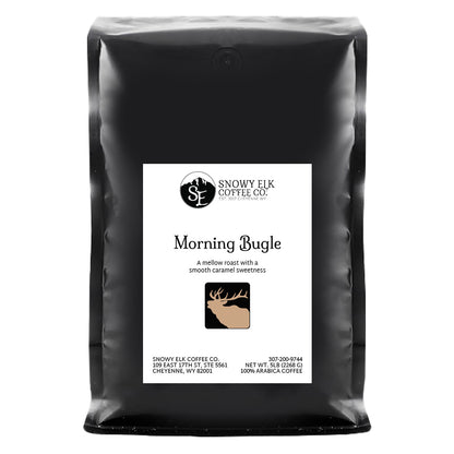 Packaging of Snowy Elk Coffee Co. Morning Bugle, showing a bag of light roast coffee with a deer logo and award badges.
