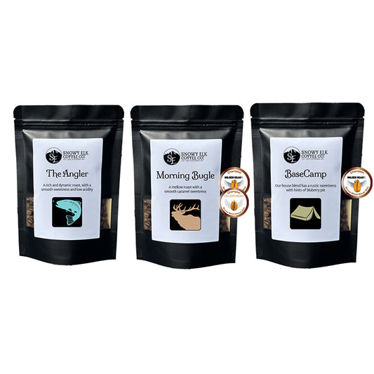 Three black coffee bags with labels 'The Angler', 'Morning Bugle', and 'Base Camp' on a white background. Three black coffee bags with labels 'The Angler', 'Morning Bugle', and 'Base Camp' on a white background.