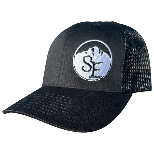 A black trucker hat with a mesh back and an adjustable snapback closure. The hat features a logo on the front panel. A black trucker hat with a mesh back and an adjustable snapback closure. The hat features a logo on the front panel.